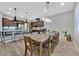 Open-concept kitchen with a spacious island, stainless steel appliances, and pendant lighting over the breakfast bar at 5801 Exbury Gardens Ct, Las Vegas, NV 89118