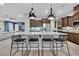 Well-lit kitchen with granite countertops, stainless steel appliances, and breakfast bar at 5801 Exbury Gardens Ct, Las Vegas, NV 89118