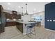 A well-lit kitchen features a central island, stainless steel appliances, and a dining area with ample natural light at 5801 Exbury Gardens Ct, Las Vegas, NV 89118