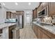 Modern kitchen featuring stainless appliances, granite countertops, and stylish backsplash at 5801 Exbury Gardens Ct, Las Vegas, NV 89118