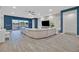 Modern living room with a large sectional sofa and sliding doors leading to backyard at 5801 Exbury Gardens Ct, Las Vegas, NV 89118