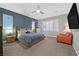 Spacious bedroom with large windows, ceiling fan, and a comfortable seating area at 5801 Exbury Gardens Ct, Las Vegas, NV 89118