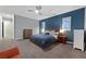 Spacious main bedroom features a tray ceiling, plush carpet, ample natural light, and elegant finishes at 5801 Exbury Gardens Ct, Las Vegas, NV 89118