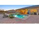 Backyard pool and spa with stone surround and ample patio space for entertaining at 5801 Exbury Gardens Ct, Las Vegas, NV 89118