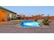 Backyard features a sparkling pool, a built-in spa, and lush landscaping at 5801 Exbury Gardens Ct, Las Vegas, NV 89118