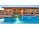 Inviting pool with in-ground spa and meticulously designed brick patio at 5801 Exbury Gardens Ct, Las Vegas, NV 89118