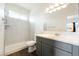 Bright bathroom featuring grey cabinets, shower stall, and a single sink at 6101 Cavalry Trl, Pahrump, NV 89060