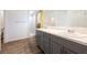 Modern bathroom with double sinks, neutral decor, and a walk-in shower at 6101 Cavalry Trl, Pahrump, NV 89060