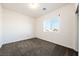 Bedroom with modern gray carpet, neutral walls, and a bright window at 6101 Cavalry Trl, Pahrump, NV 89060