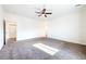 Spacious carpeted bedroom with a ceiling fan, and neutral paint palette at 6101 Cavalry Trl, Pahrump, NV 89060