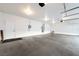 Large three car garage with white walls, bright lighting, concrete flooring, and a single entry door at 6101 Cavalry Trl, Pahrump, NV 89060