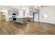 Open-concept kitchen featuring gray cabinets, stainless steel appliances, a central island, and beautiful hardwood flooring at 6101 Cavalry Trl, Pahrump, NV 89060