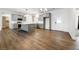 Open-concept living area with grey kitchen cabinets, island and wood flooring at 6101 Cavalry Trl, Pahrump, NV 89060