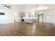 Expansive living area with sleek hardwood floors that seamlessly connect to a modern kitchen, perfect for entertaining guests at 6101 Cavalry Trl, Pahrump, NV 89060
