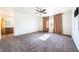 Spacious main bedroom with plush carpeting, neutral tones, and a glimpse into the en-suite bathroom at 6101 Cavalry Trl, Pahrump, NV 89060