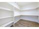 Spacious walk-in closet with ample shelving and wood-look floors offers plenty of storage at 6101 Cavalry Trl, Pahrump, NV 89060