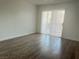 Bedroom with wood-look floors and sliding door access to outdoor balcony at 6250 W Flamingo Rd # 88, Las Vegas, NV 89103