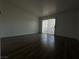 Bedroom with wood-look floors and sliding door access to outdoor balcony at 6250 W Flamingo Rd # 88, Las Vegas, NV 89103