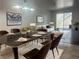 Modern dining room with a black dining table set for six and a view into the living area at 6250 W Flamingo Rd # 88, Las Vegas, NV 89103