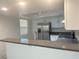 Bright kitchen featuring white cabinets, stainless steel appliances, and a breakfast bar with sink and granite countertops at 6250 W Flamingo Rd # 88, Las Vegas, NV 89103