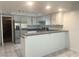 Bright kitchen featuring white cabinets, stainless steel appliances, and a breakfast bar at 6250 W Flamingo Rd # 88, Las Vegas, NV 89103