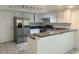 Bright kitchen featuring white cabinets, stainless steel appliances, and a breakfast bar with sink at 6250 W Flamingo Rd # 88, Las Vegas, NV 89103