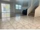 Bright living room featuring tile flooring, a sliding door, and staircase at 6250 W Flamingo Rd # 88, Las Vegas, NV 89103