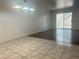Open floor plan with both tile and wood floors, and an modern light fixture, leading to the back entrance at 6250 W Flamingo Rd # 88, Las Vegas, NV 89103