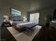 Well-lit main bedroom featuring a king-size bed with a padded headboard and access to a private balcony at 6250 W Flamingo Rd # 88, Las Vegas, NV 89103