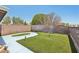 Expansive backyard featuring a well-maintained lawn and stylish lighting fixtures at 667 Del Prado Dr, Boulder City, NV 89005