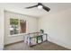 Bright bedroom featuring a ceiling fan and a window with a view of the outdoors at 667 Del Prado Dr, Boulder City, NV 89005