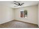 Bedroom with carpet flooring and a window view of the landscaped front yard at 667 Del Prado Dr, Boulder City, NV 89005