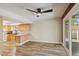 Open kitchen featuring light wood cabinets, laminate countertops, and a sliding glass door to the backyard at 667 Del Prado Dr, Boulder City, NV 89005
