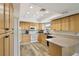Bright kitchen featuring wooden cabinets, white appliances, and laminate countertops at 667 Del Prado Dr, Boulder City, NV 89005
