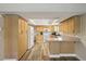 Bright kitchen with light wood cabinets, laminate countertops, and ample storage space at 667 Del Prado Dr, Boulder City, NV 89005