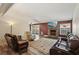 Open living room features hardwood floors, a stone fireplace, and backyard access at 667 Del Prado Dr, Boulder City, NV 89005