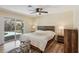 Bedroom featuring hardwood floors, a ceiling fan, and a sliding glass door leading to backyard at 667 Del Prado Dr, Boulder City, NV 89005