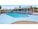 Backyard view of the in-ground pool, surrounded by concrete, a white fence, and desert landscaping at 667 Del Prado Dr, Boulder City, NV 89005