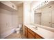 Bathroom featuring a white vanity with a large mirror, a toilet, and a shower-tub combo at 7155 S Durango Dr # 205, Las Vegas, NV 89113