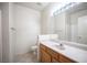 Bright bathroom features a vanity with a wide mirror, a toilet, and tile flooring at 7155 S Durango Dr # 205, Las Vegas, NV 89113