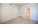 Bedroom featuring tile flooring, white walls, and entryways to other rooms at 7155 S Durango Dr # 205, Las Vegas, NV 89113