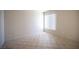 Spacious bedroom with a large window and tile flooring creating a bright and airy space at 7155 S Durango Dr # 205, Las Vegas, NV 89113