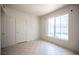 Bedroom with a large window with outside view and tile flooring at 7155 S Durango Dr # 205, Las Vegas, NV 89113