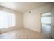Bedroom with tile flooring, a large window, and neutral walls, offering a serene atmosphere at 7155 S Durango Dr # 205, Las Vegas, NV 89113