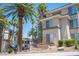 Condominium building featuring manicured landscaping, palm trees and neutral color scheme, offering a welcoming and well-maintained facade at 7155 S Durango Dr # 205, Las Vegas, NV 89113