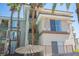 Condo building exterior with private balconies and lush palm trees, offering residents a tranquil retreat at 7155 S Durango Dr # 205, Las Vegas, NV 89113