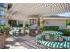 Community outdoor grilling area featuring a built-in grill, covered pergola, and picnic tables at 7155 S Durango Dr # 205, Las Vegas, NV 89113