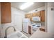 Compact kitchen featuring ample cabinetry, essential appliances, and tile flooring at 7155 S Durango Dr # 205, Las Vegas, NV 89113