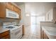 Efficient kitchen with gas range, microwave, and connection to the dining area at 7155 S Durango Dr # 205, Las Vegas, NV 89113