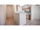 Functional kitchen with breakfast bar, white appliances, and tile flooring throughout at 7155 S Durango Dr # 205, Las Vegas, NV 89113
